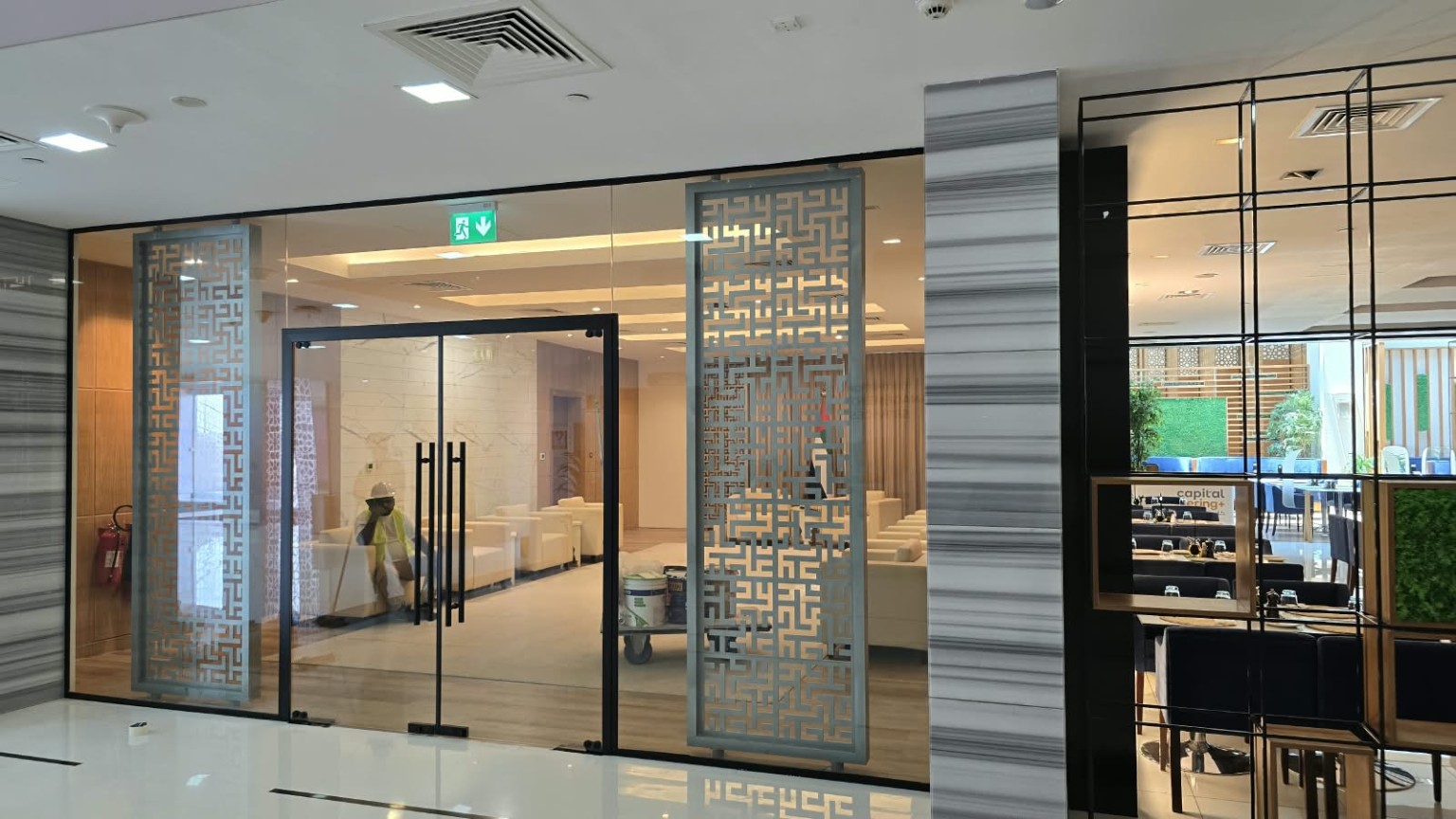 Frameless glass entrance doors and decorative screens