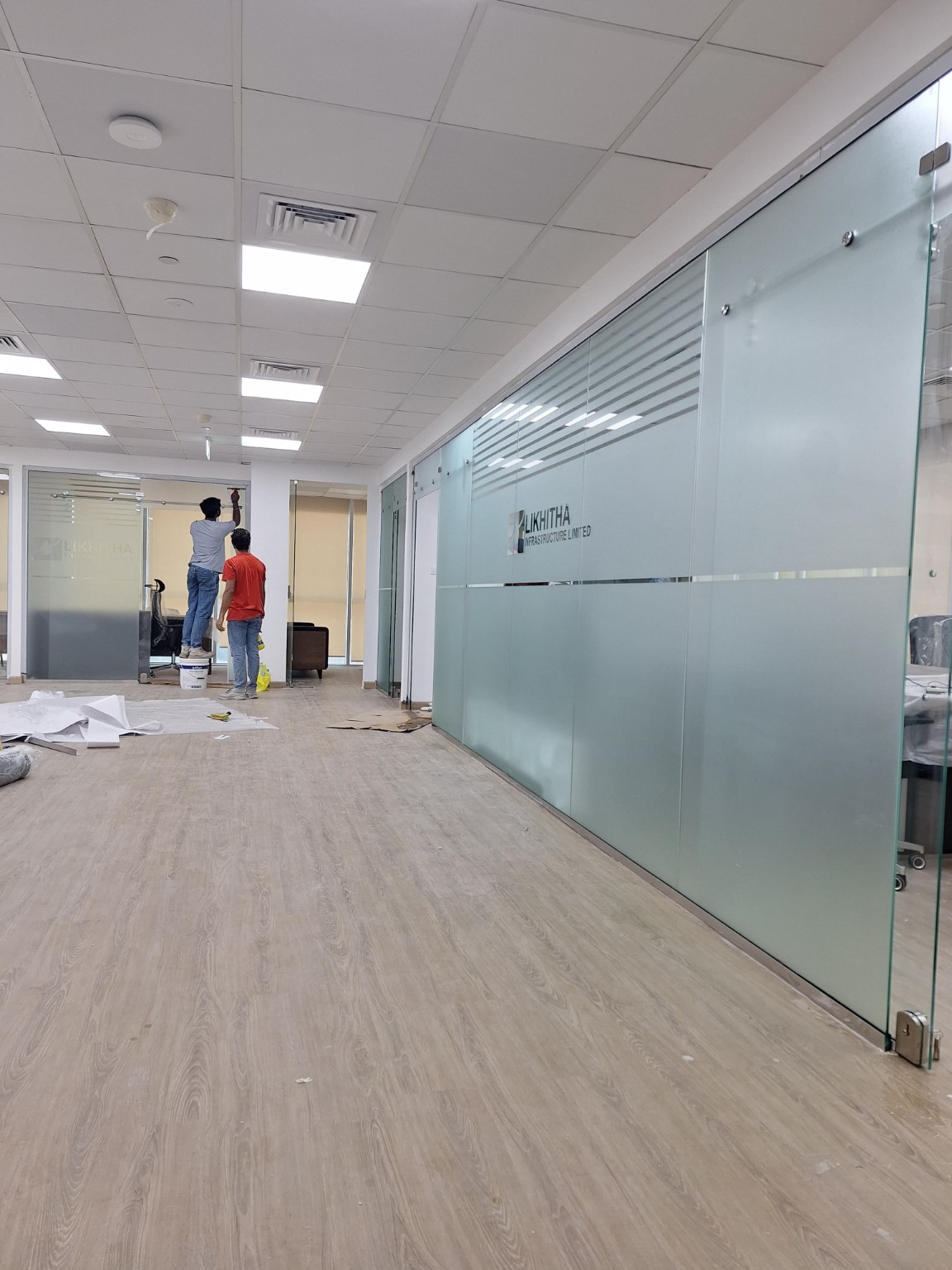 Glass office partition installation with frosted bands